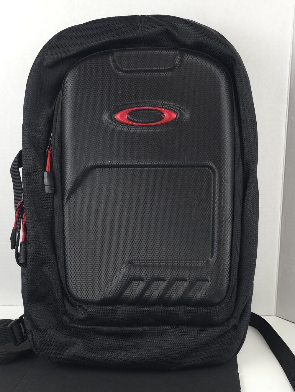 Oakley Motion Tech 15L Backpack 92656-01K Black Hard Molded Front Red Logo
